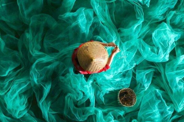 Fisherwoman Mends Nets Amid Xiapu’s Turquoise Sea Fisherwoman_Mends_Nets_Amid_Xiapu_s_Turquoise_Sea