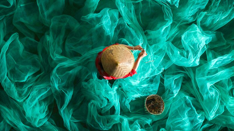 Fisherwoman_Mends_Nets_Amid_Xiapu_s_Turquoise_Sea